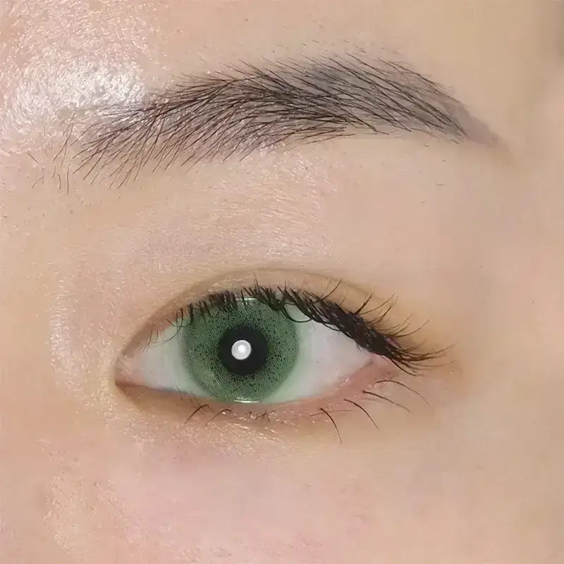 mint green colored contacts close view